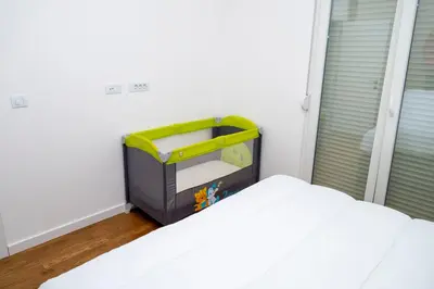 a childs toy in a room with a bed at RiverBank Apartmani in Podgorica