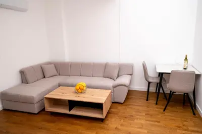 a living room with a couch and a table at RiverBank Apartmani in Podgorica