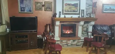 a living room with a fireplace and a television at Anika in Podgorica