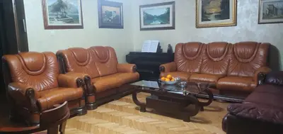 a living room with two leather couches and a coffee table at Anika in Podgorica