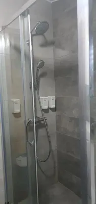 a shower with a shower head in a bathroom at Anika in Podgorica