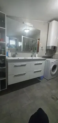 a kitchen with a sink and a washing machine at Anika in Podgorica