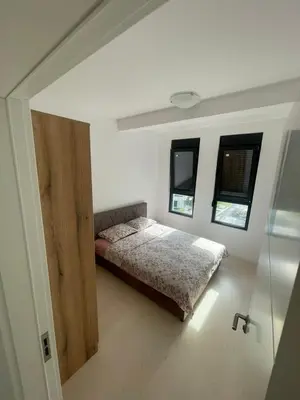a bedroom with a bed and a wooden door at Triumph residence Bar in Bar