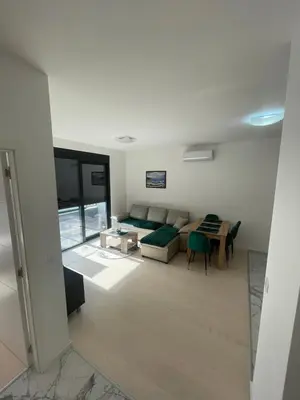 a living room with a couch and a table at Triumph residence Bar in Bar