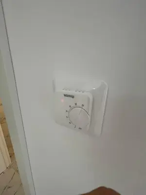a white appliance on a white wall at Triumph residence Bar in Bar