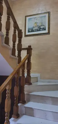 a staircase with a picture of a boat on the wall at Vila Anika in Podgorica
