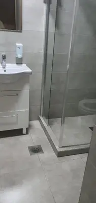 a bathroom with a shower and a sink at Vila Anika in Podgorica