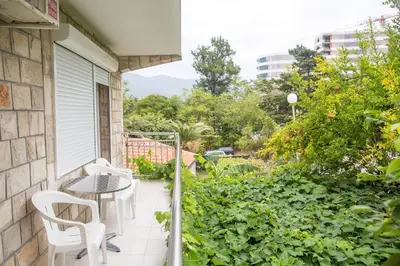 a balcony with a table and chairs on a house at Guest House Vucicevic in Budva
