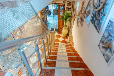 a staircase in a house with a tile floor at Guest House Vucicevic in Budva