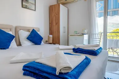 a bedroom with two beds with towels on them at Guest House Vucicevic in Budva
