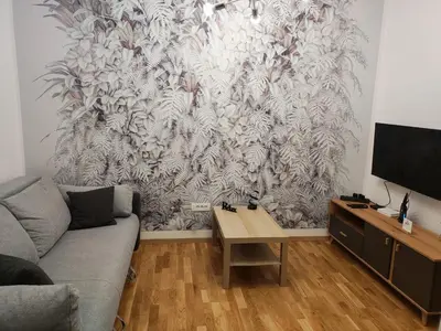 a living room with a couch and a wall mural at Apartments Sunny in Becici