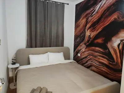 a bedroom with a bed with a painting on the wall at Apartments Sunny in Becici