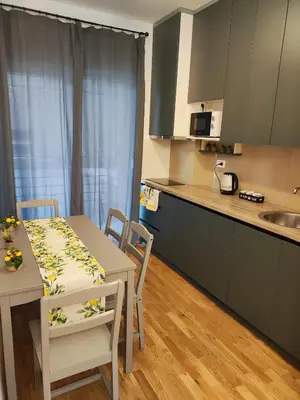 a kitchen and dining room with a table and chairs at Apartments Sunny in Becici