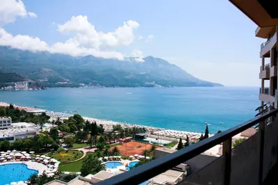 a view of the ocean from a balcony of a resort at Apartments Location by Chabad House in Becici
