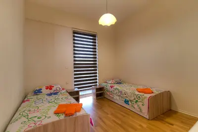 a bedroom with two beds and a window at Apartments Location by Chabad House in Becici
