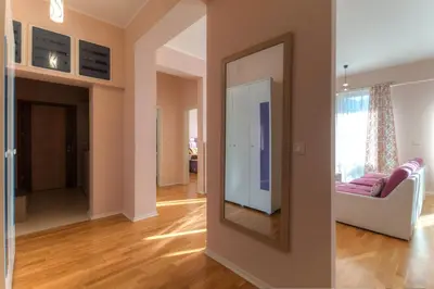 a living room with a mirror and a couch at Apartments Location by Chabad House in Becici