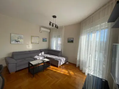 a living room with a couch and a table at Sunny Corner Apartment in Podgorica