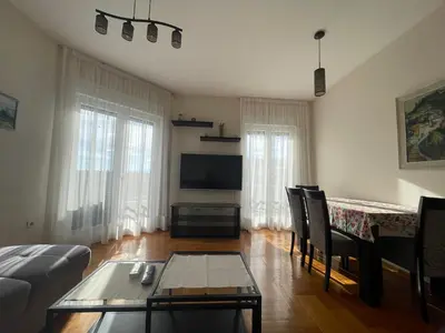a living room with a couch and a table at Sunny Corner Apartment in Podgorica
