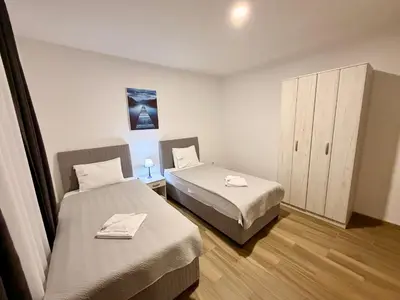 a room with two beds and a cabinet in it at M apartment 3 in Bar