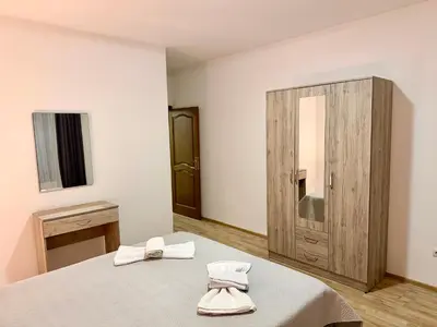 a bedroom with a bed and a wooden cabinet at M apartment 3 in Bar