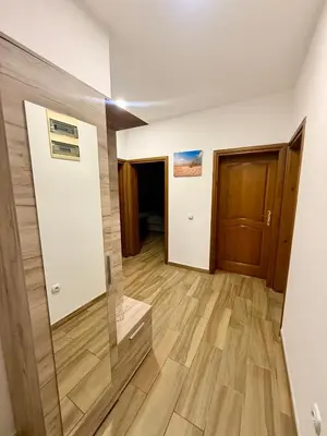 a living room with a wooden floor and a door at M apartment 3 in Bar
