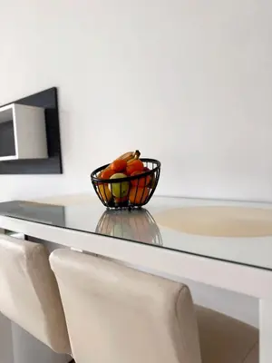 a bowl of fruit sitting on a glass table at Cozy seaside studio in Bar