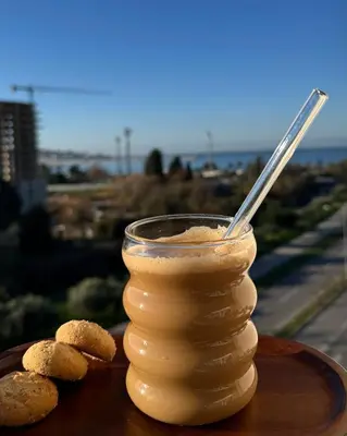a glass jar of peanut butter on a plate with cookies at Cozy seaside studio in Bar