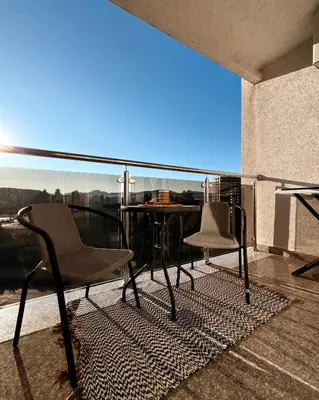 a balcony with a table and chairs and a view at Cozy seaside studio in Bar