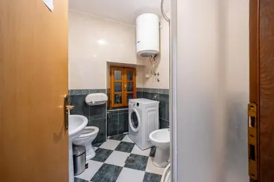 a bathroom with three toilets and a sink at Tara Rooms In The Heart Of Old Town Kotor in Kotor