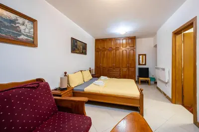 a small bedroom with a bed and a couch at Tara Rooms In The Heart Of Old Town Kotor in Kotor