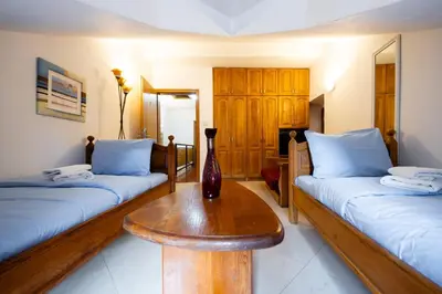 a room with two beds and a vase on a table at Tara Rooms In The Heart Of Old Town Kotor in Kotor