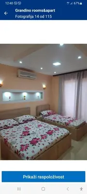 two beds in a room with flowers on them at Grandino Rooms & Apartments in Ulcinj