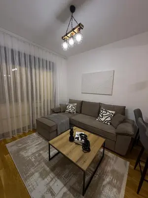 a living room with a couch and a table at Zati Homes Ulcinj in Ulcinj