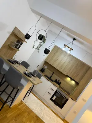 a kitchen with a table and chairs in a room at Zati Homes Ulcinj in Ulcinj