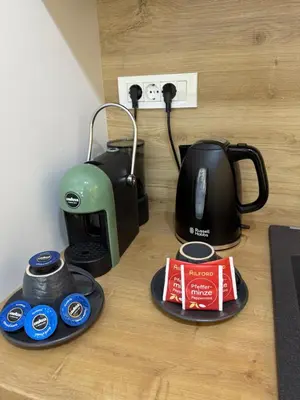 a coffee maker and a toaster on a table at Zati Homes Ulcinj in Ulcinj