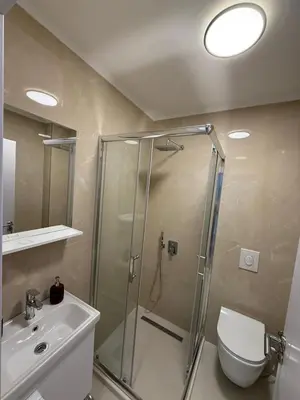 a bathroom with a shower and a toilet and a sink at Zati Homes Ulcinj in Ulcinj