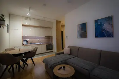 a living room with a couch and a table at Posh Residence Podgorica in Podgorica