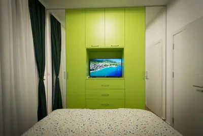 a bedroom with a bed with a tv on it at Posh Residence Podgorica in Podgorica