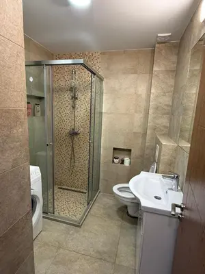 a bathroom with a shower and a toilet and a sink at Lindi in Ulcinj