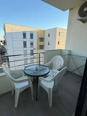 a patio with a table and chairs on a balcony at Lindi in Ulcinj