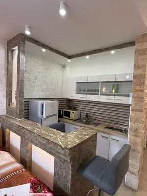 a kitchen with a granite counter top in a room at Lindi in Ulcinj