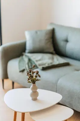 a white coffee table with a vase on it in a living room at The View - Apartment with Pool in Blizikuće