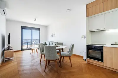 a kitchen and dining room with a table and chairs at The View - Apartment with Pool in Blizikuće