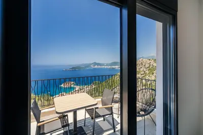 a view of the ocean from a balcony at The View - Apartment with Pool in Blizikuće