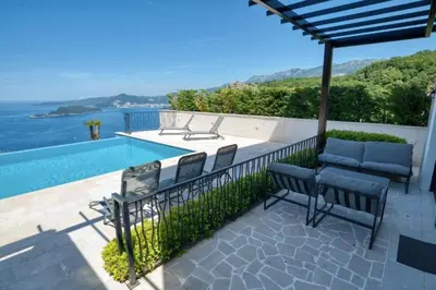a patio with a table and chairs and a swimming pool at The View - Apartment with Pool in Blizikuće