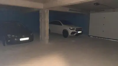 a parking garage with two cars parked in it at Apartment Hrubosovic Dobra voda in Dobra Voda