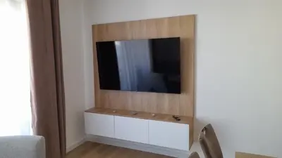 a living room with a tv on a wall at Apartment Hrubosovic Dobra voda in Dobra Voda