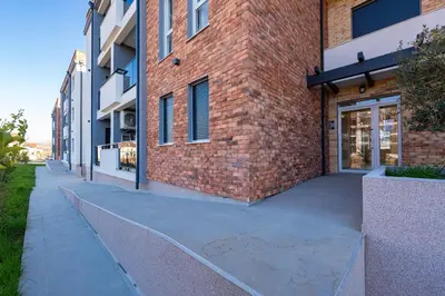 a walkway next to a brick building at Quince Apartments in Podgorica