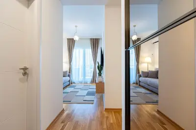 a hallway leading to a living room with a couch at Quince Apartments in Podgorica