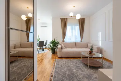 a living room with a couch and a table at Quince Apartments in Podgorica